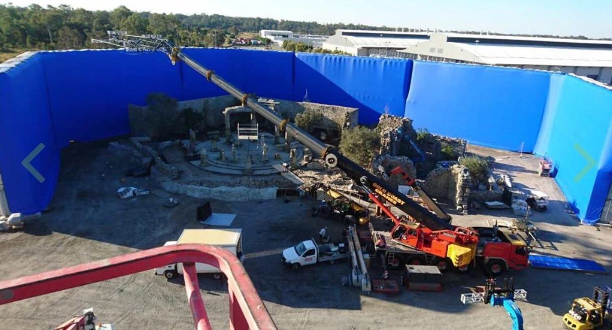Blue AirWall corner on a backlot with a crane and unit vehicles